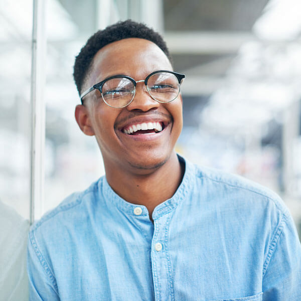 young man smiling in office