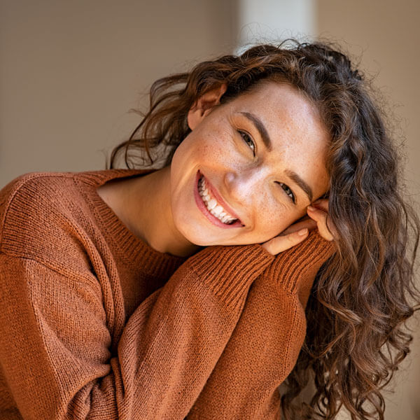 young woman smiling with head turned