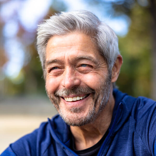 mature man smiling outdoors