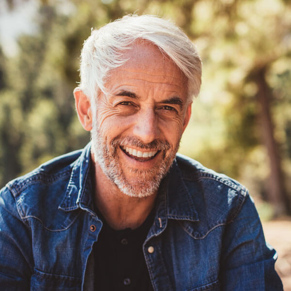 mature man smiling outdoors